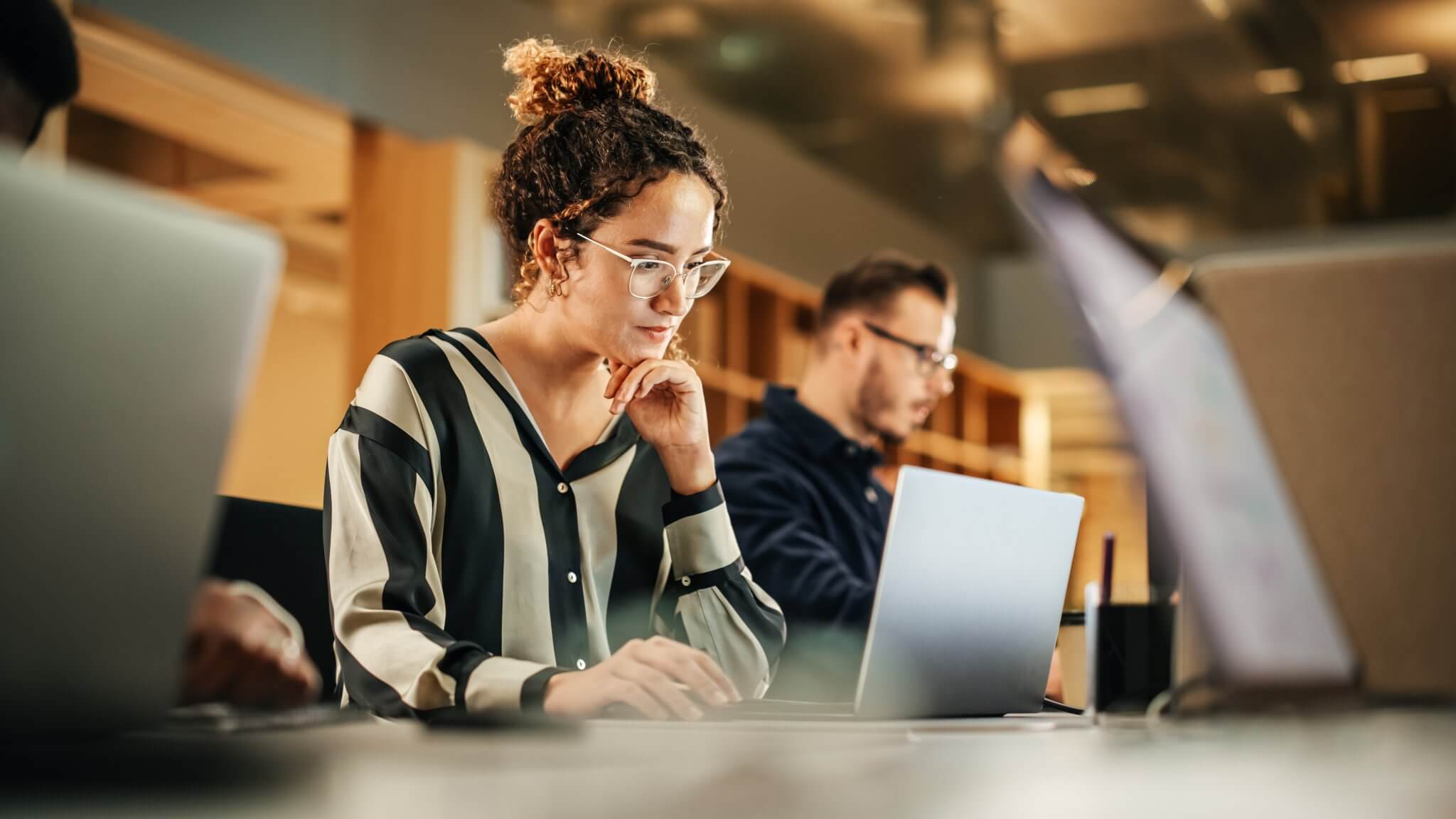 Portrait,Of,Enthusiastic,Hispanic,Young,Woman,Working,On,Computer,In