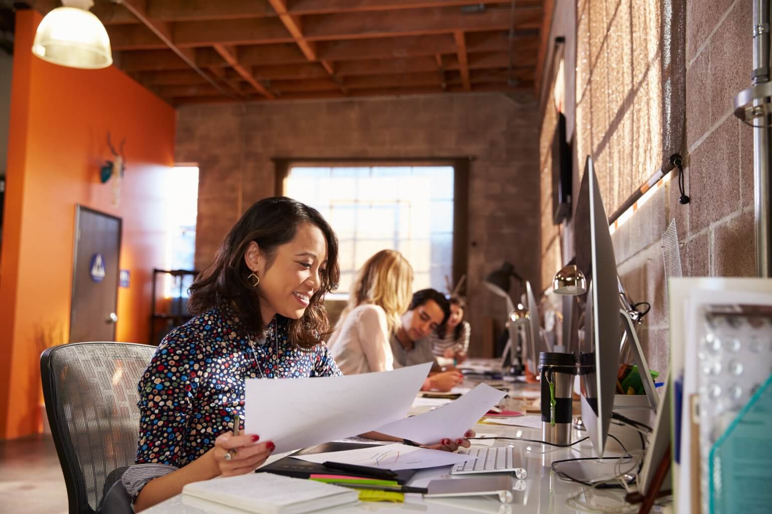 Team,Of,Designers,Working,At,Desks,In,Modern,Office