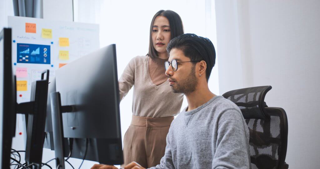 IT workers looking at screen reviewing network redundacy strategy