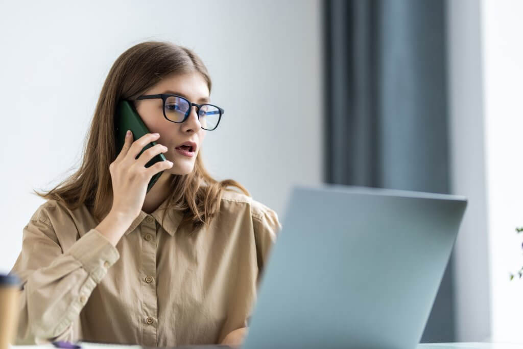 Cheerful,Young,Beautiful,Woman,In,Glasses,Talking,On,Mobile,Phone