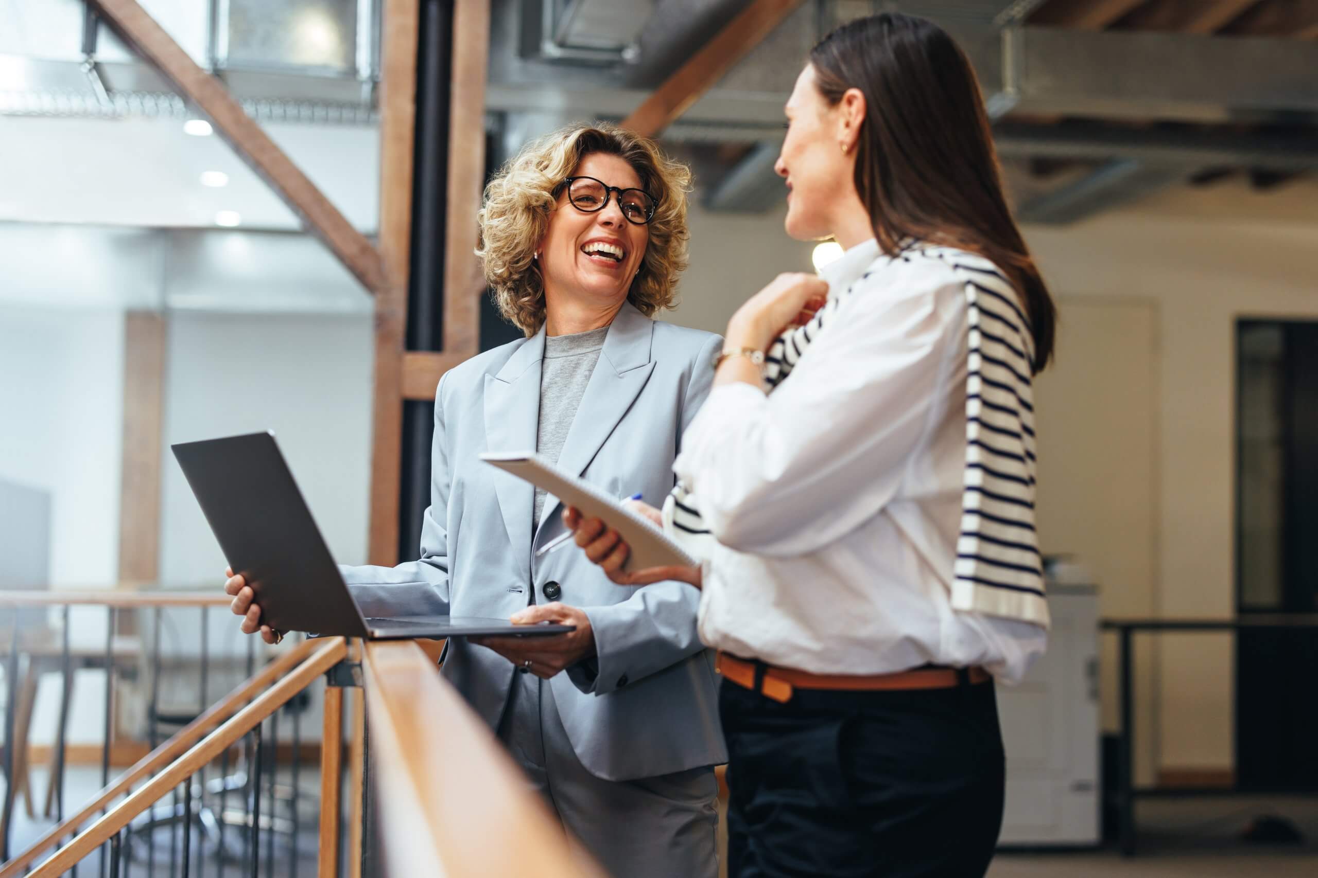 Business,Women,Smiling,As,They,Have,A,Meeting,On,A