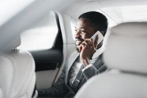 Happy,Afro,Businessman,Talking,On,Cellphone,In,Car,,Sitting,On