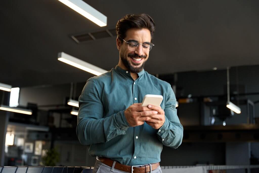 Smiling,Handsome,Latin,Business,Man,Executive,Or,Employee,Using,Cell