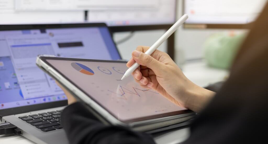 Close up of manager's (woman) hand, using a stylus pen to point at tablet