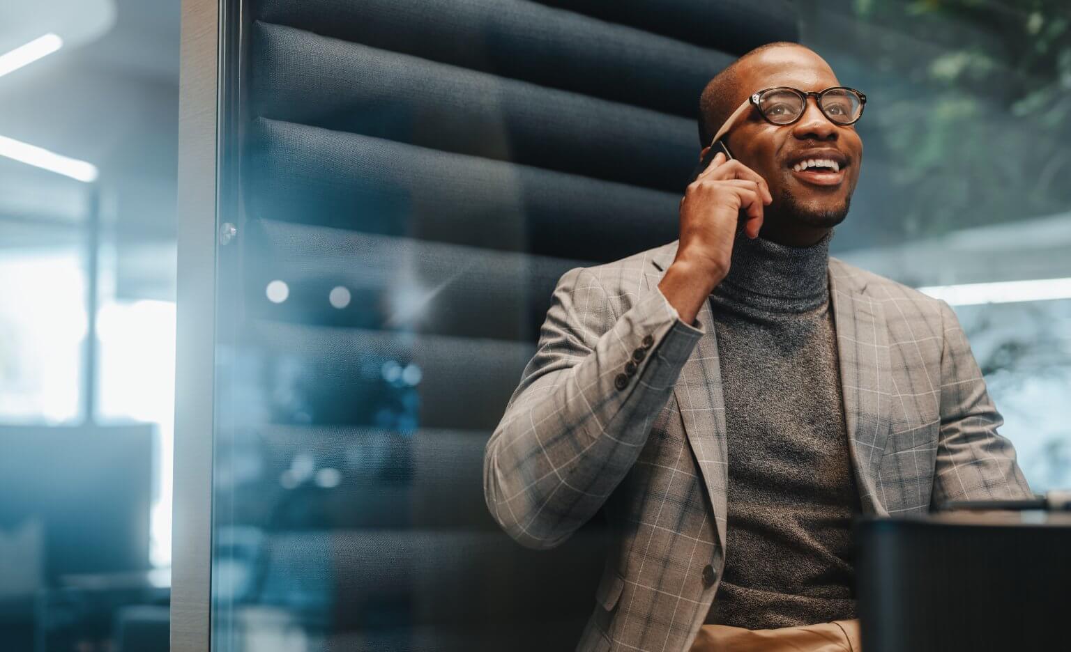 Businessman,In,An,Office,Space,,Using,His,Smartphone,To,Communicate